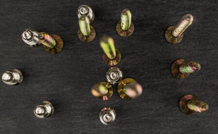 Group of fifteen whole metallic glossy bolt flatlay on grey stone