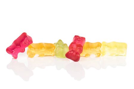 Lot of whole gummy bear in row isolated on white backgroundの写真素材