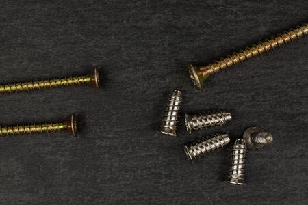 Group of eight whole metallic glossy bolt flatlay on grey stone