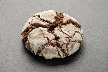 One whole baked chocolate brownie cookie on white background