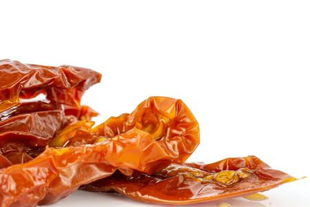 Lot of slices of dry red cherry tomato closeup isolated on white backgroundの写真素材