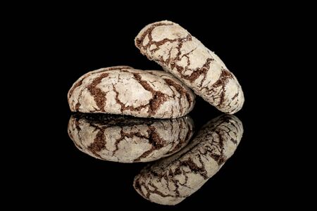 Group of two whole baked chocolate brownie cookie isolated on black glassの写真素材
