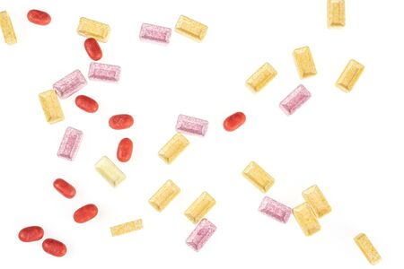 Lot of whole disordered sweet pastel candy flatlay isolated on white background