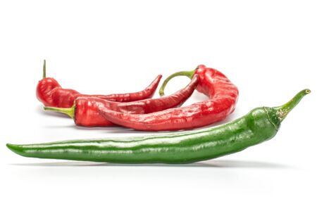 Group of four whole fresh hot pepper green in focus isolated on white backgroundの写真素材
