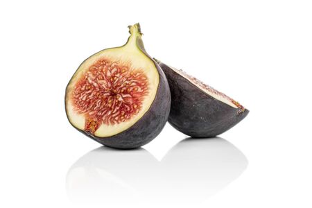 Group of two halves of sweet purple fig isolated on white backgroundの写真素材