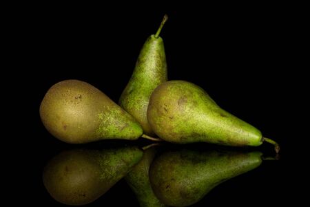 Group of three whole fresh green pear isolated on black glassの写真素材