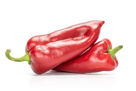 Group of two whole sweet red bell pepper isolated on white backgroundの写真素材