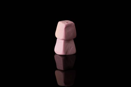 Group of two whole soft pastel candy isolated on black glassの写真素材