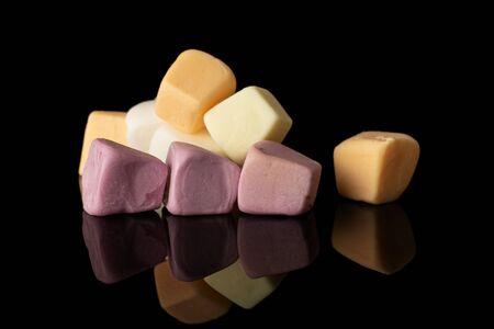 Lot of whole soft pastel candy isolated on black glassの写真素材