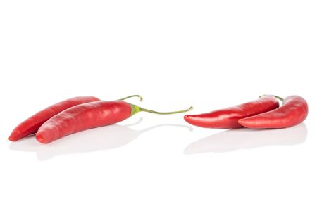 Group of four whole hot red chili cayenne isolated on white backgroundの写真素材