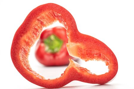 Group of one whole one slice of sweet red bell pepper front focus isolated on white background