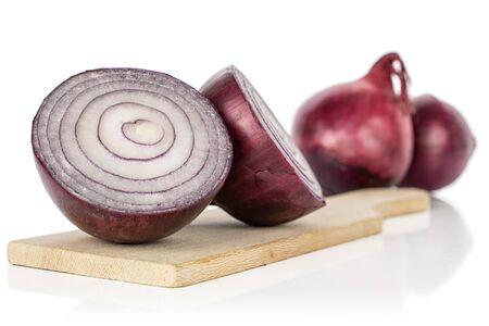 Group of two whole two halves of tasty onion red on wooden cutting board isolated on white backgroundの写真素材