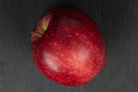 One whole fresh apple red delicious flatlay on grey stoneの写真素材