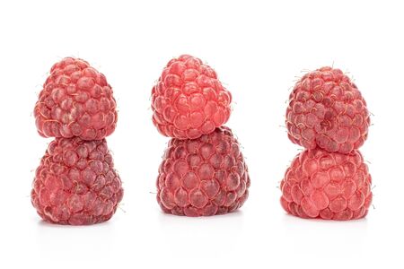 Lot of whole fresh crimson raspberry in white sauce bowl isolated on white backgroundの写真素材