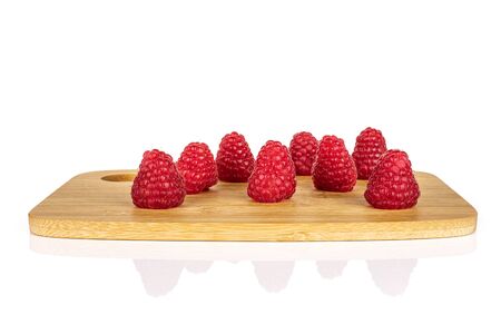 Group of eight whole fresh red raspberry on bamboo cutting board isolated on white backgroundの写真素材