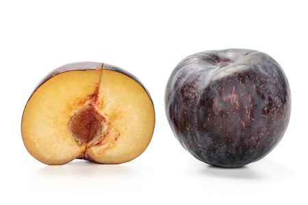 Group of one whole one half of fresh red plum isolated on white backgroundの写真素材