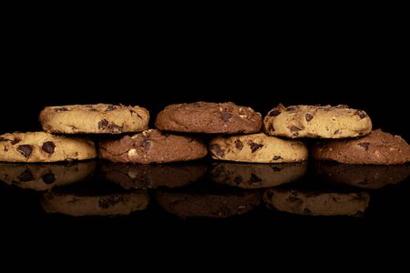 Group of seven whole sweet brown cookie isolated on black glassの写真素材