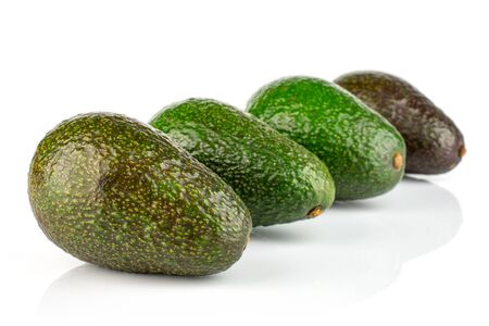 Group of four whole fresh green avocado placed diagonally isolated on white backgroundの写真素材
