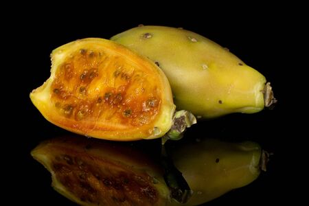 Group of one whole one half of prickly green opuntia isolated on black glassの写真素材