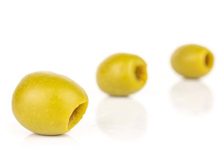 Group of three whole pitted green olive isolated on white backgroundの写真素材