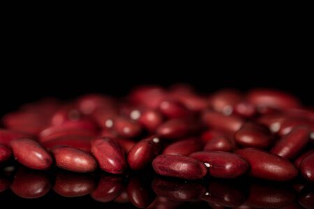 Lot of whole diet fresh red kidney beans isolated on black glassの写真素材