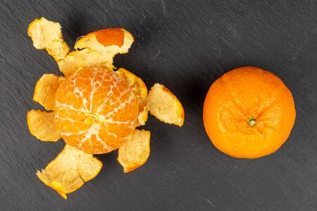 Group of two whole fresh orange mandarine flatlay on grey stoneの写真素材