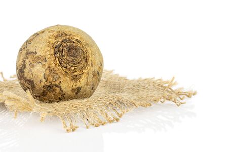 One whole raw red beetroot on natural sackcloth isolated on white backgroundの写真素材