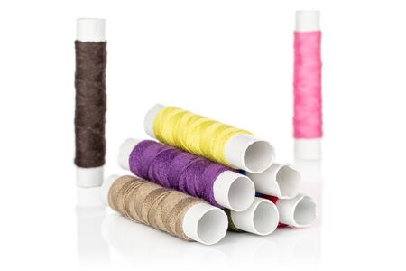 Group of eight whole sewing thread spool heap isolated on white background