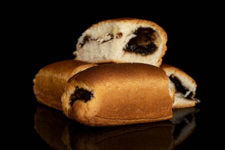 Group of four whole sweet czech bun heap isolated on black glass