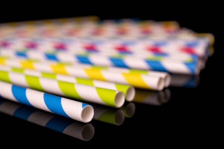 Lot of whole disordered paper straw isolated on black glassの写真素材
