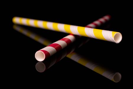 Group of two whole paper straw isolated on black glassの写真素材