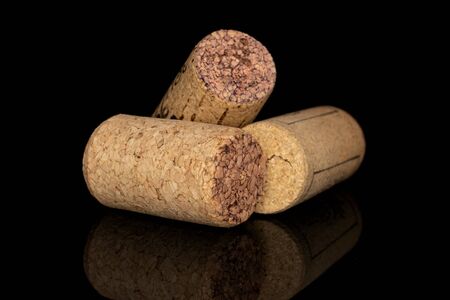 Group of three whole common wine cork isolated on black glassの写真素材