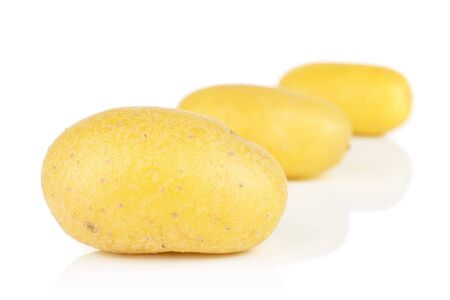 Group of three whole pale yellow potato placed diagonally isolated on white backgroundの写真素材