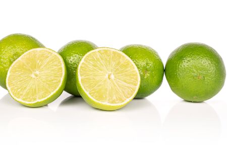 Group of four whole two halves of sour green lime isolated on white backgroundの写真素材