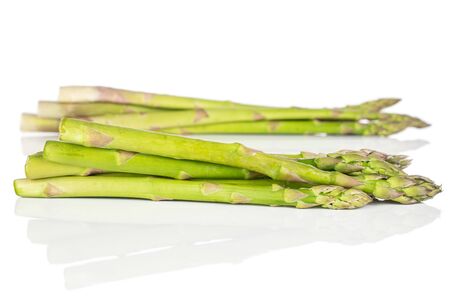 Lot of whole healthy green asparagus front focus isolated on white backgroundの写真素材