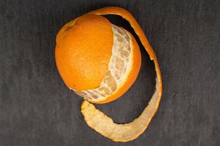 One whole fresh orange mandarin flatlay on grey stoneの写真素材