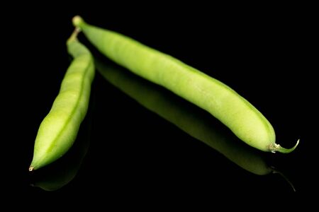 Group of two whole snap green bean isolated on black glass