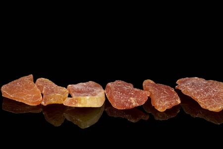 Group of six whole dried orange papaya piece isolated on black glassの写真素材