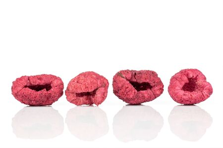 Group of four whole dried raspberry isolated on white background