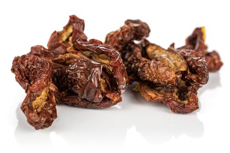 Lot of whole dried red tomato piece isolated on white backgroundの写真素材