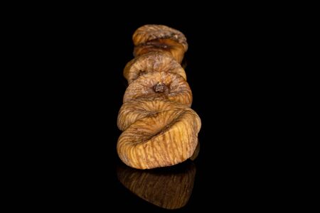 Lot of whole dried fig row isolated on black glass