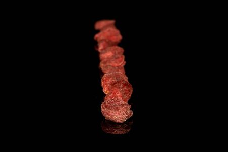 Lot of whole dried red goji row isolated on black glass