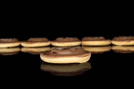 Group of six whole chocolate biscuit front focus isolated on black glassの写真素材