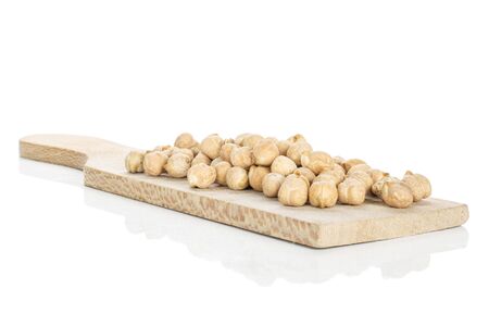 Lot of whole fresh tan chickpea on wooden cutting board isolated on white backgroundの写真素材