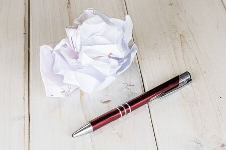 One whole writing ballpoint pen with white paper on white woodの写真素材
