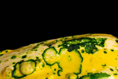 One whole beautiful decorative gourd closeup isolated on black glassの写真素材