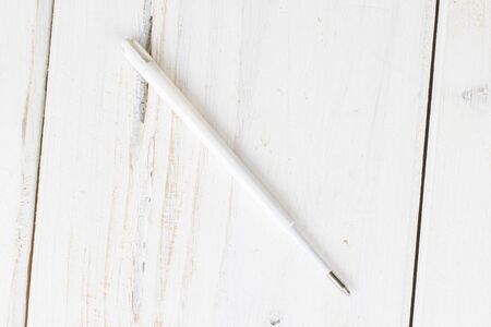 One piece of writing ballpoint pen flatlay on white woodの写真素材