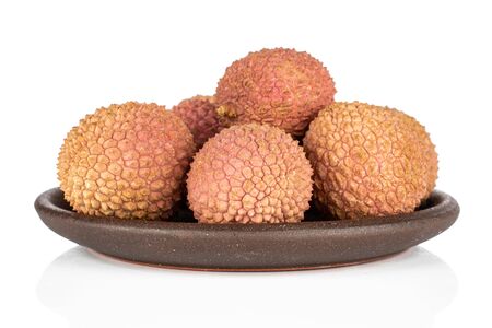 Group of five whole fresh lychee with brown ceramic coaster isolated on white backgroundの写真素材