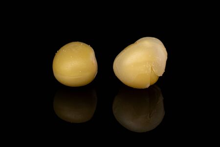 Group of two whole canned pea isolated on black glass