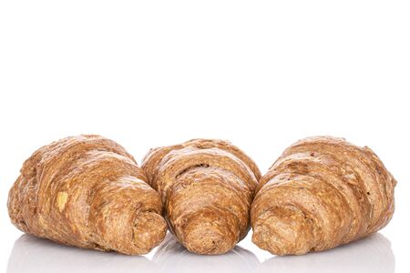 Group of three whole baked wholegrain croissant isolated on whiteの写真素材